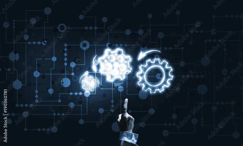 Glowing cogwheel mechanism icon on dark background as symbol of teamwork Glowing cogwheel mechanism icon on dark background as symbol of teamwork