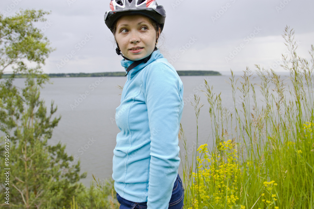 Girl in a bicycle helmet. Tourist base in the forest. Girl in a bicycle helmet. Tourist base in the forest.