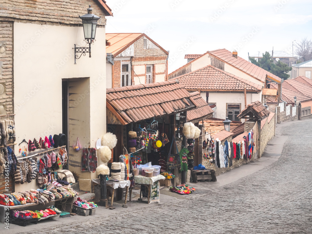 outdoor market with carpets and traditional souvenirs on street in Mestia, Georgia