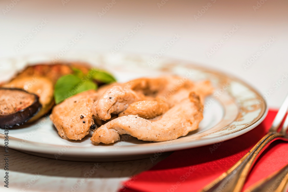 Pieces of roasted chicken and vegetables on plate Pieces of roasted chicken and vegetables on plate