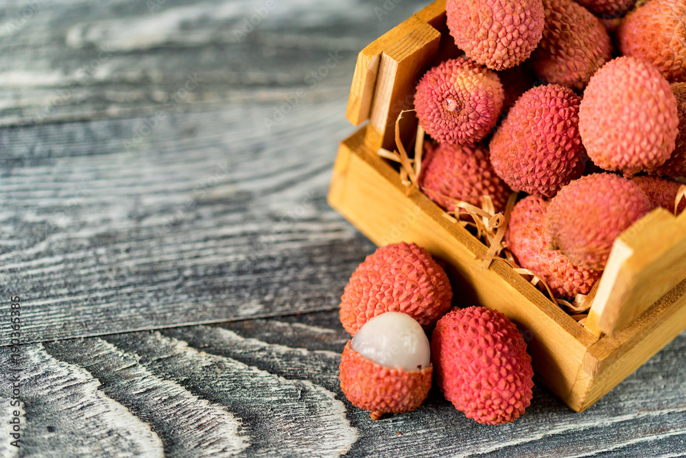 Lychee fruit in wooden box close