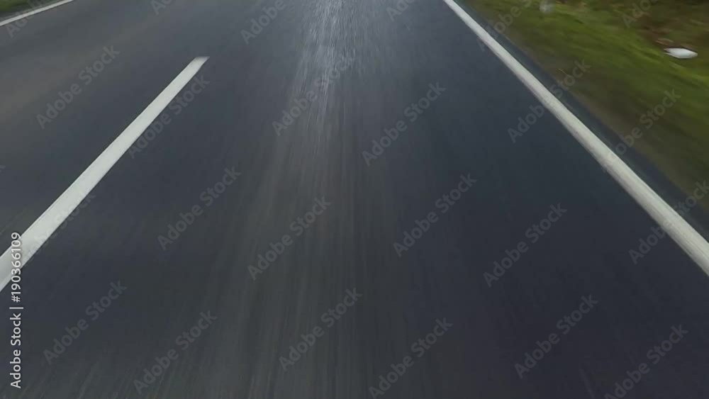 car driving on a asphalt country road - POV - View of the road in the front of the car car driving on a asphalt country road - POV - View of the road in the front of the car