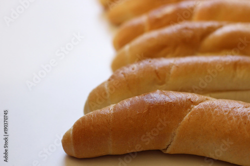 Delicious freshly baked rolls on a wood background the highest quality. Ideal shape and color blush removed from the oven. Blurred background.