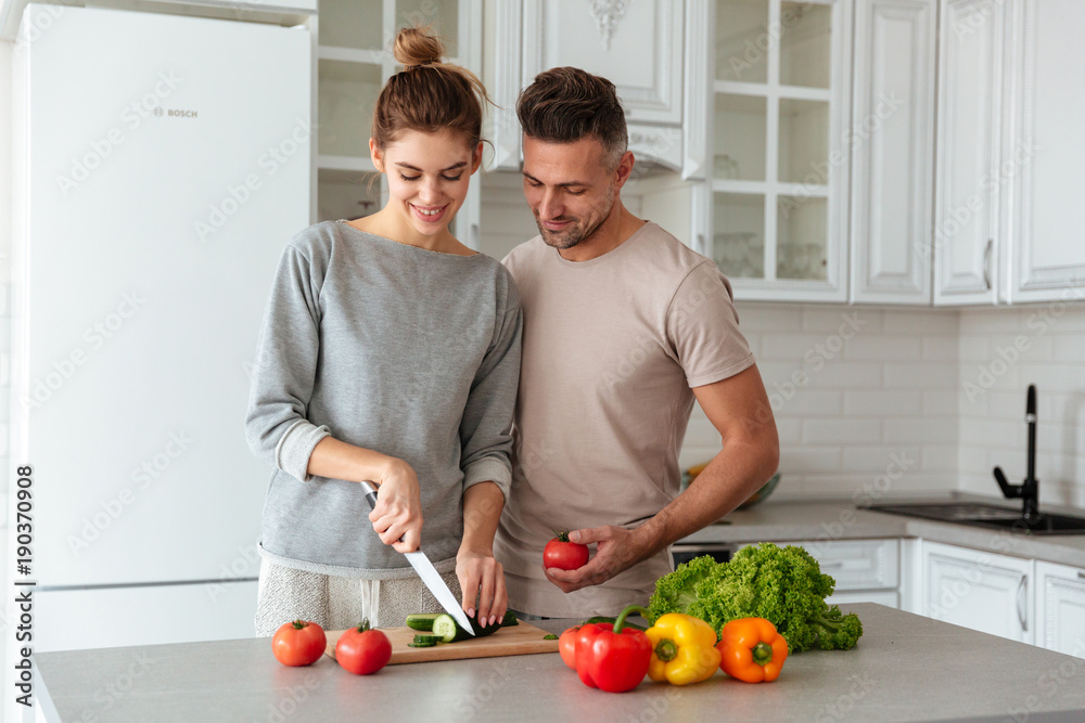 Portrait of a smiling loving couple cooking salad Portrait of a smiling loving couple cooking salad