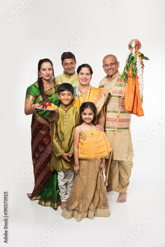 Indian family celebrating Gudi Padwa or Ugadi festival, which is a new year in Hindu tradition
 photo