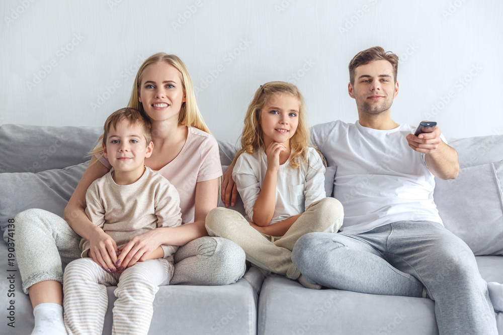 beautiful young family watching movie at home on weekend beautiful young family watching movie at home on weekend