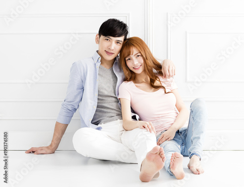 relaxed couple sitting together on the floor