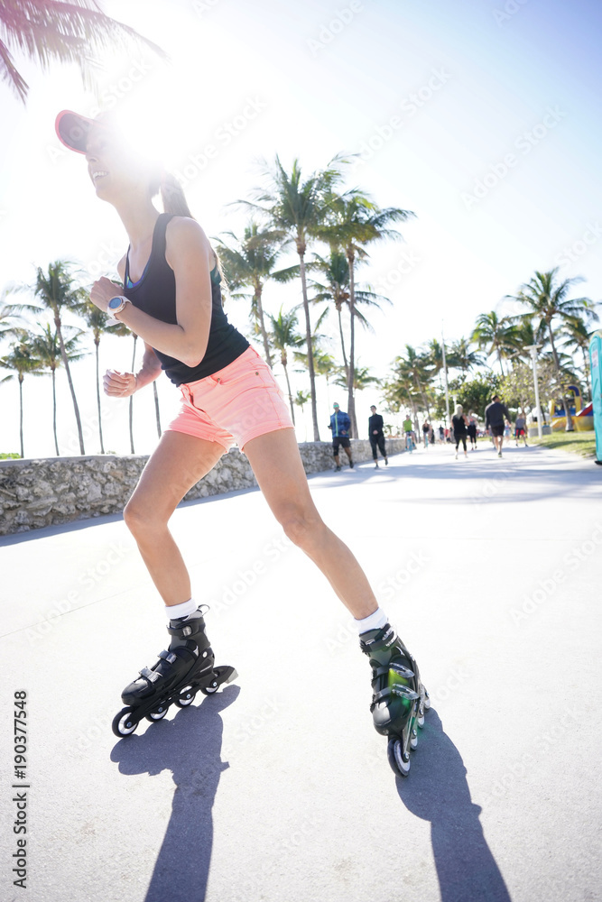 Trendy girl roller-skating in Miami South Beach promenade Photos | Adobe  Stock