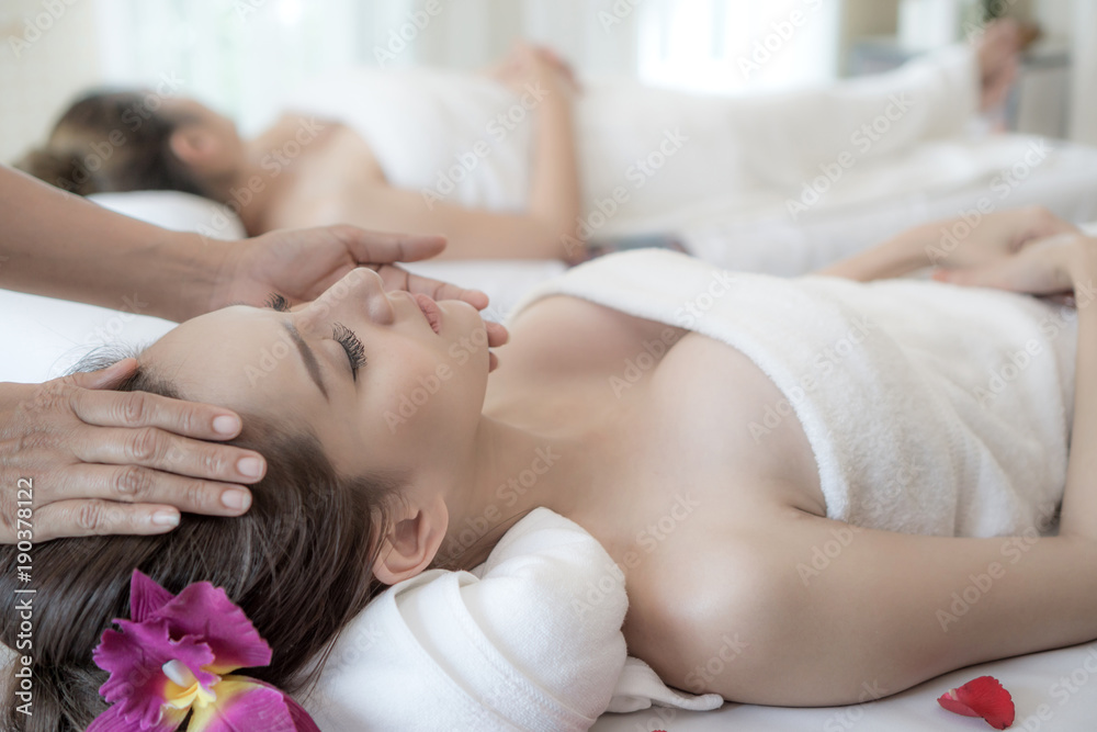 beautiful and healthy young woman relaxing with face massage at beauty spa salon beautiful and healthy young woman relaxing with face massage at beauty spa salon