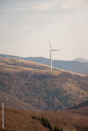 Wind turbines in the mountain, at a sunny autumn day