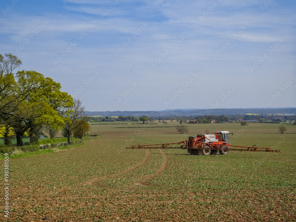 Fototapeta premium tractor crop spraying a field