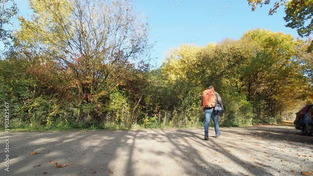 Man preparing to backpack into forest in Eifel Germany for photography Man preparing to backpack into forest in Eifel Germany for photography