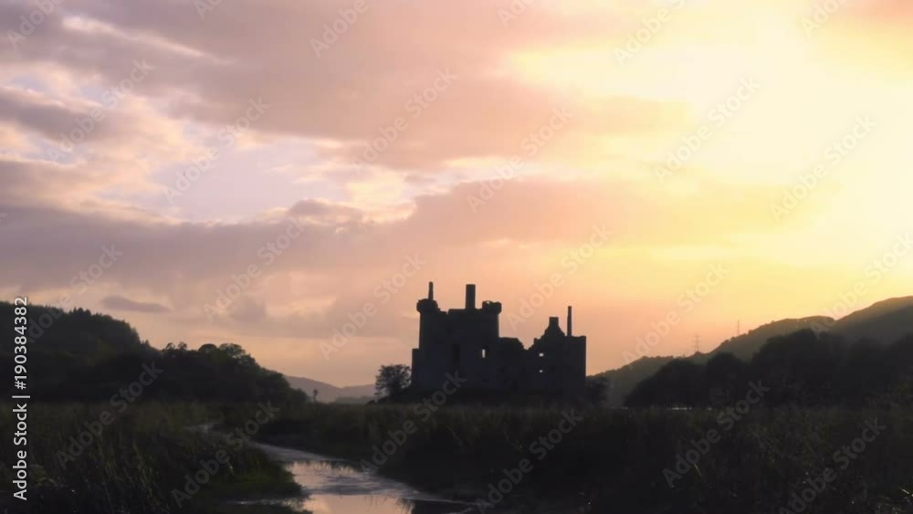 Ancient Castle on a lake in Scotland at Sunset Ancient Castle on a lake in Scotland at Sunset