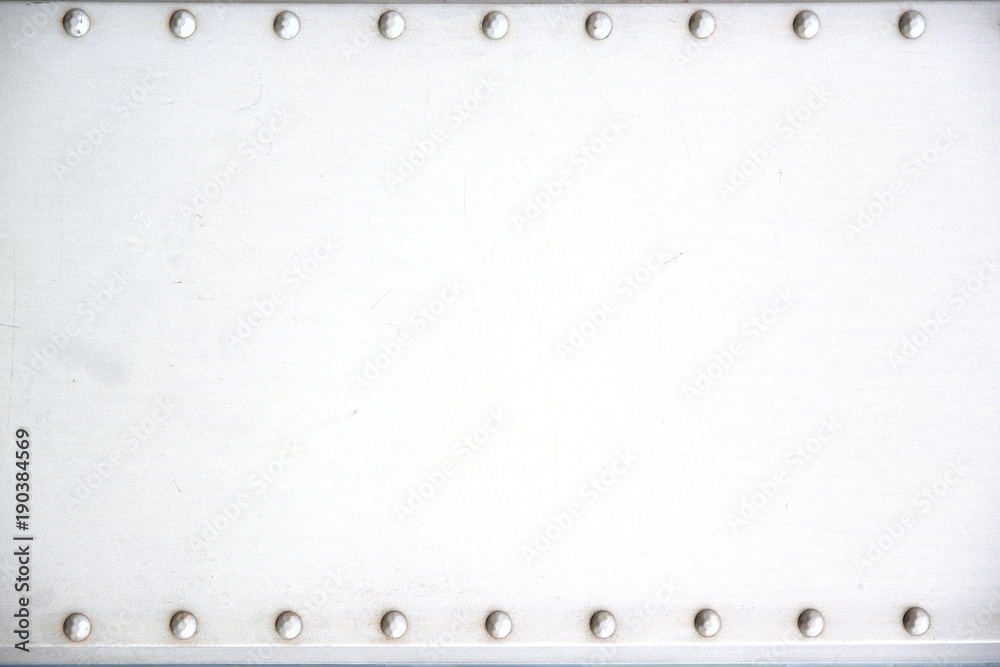 Metallic background framed by rivets and empty copy space for Editor's text. Metallic background framed by rivets and empty copy space for Editor's text.