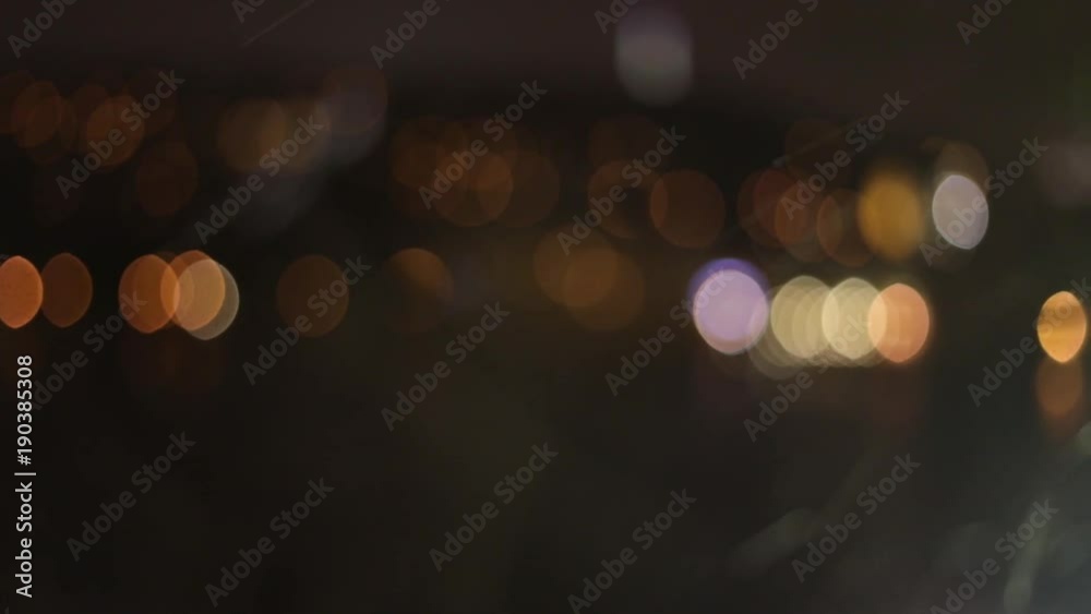 Snow falls against the background of the night lights of the city Snow falls against the background of the night lights of the city
