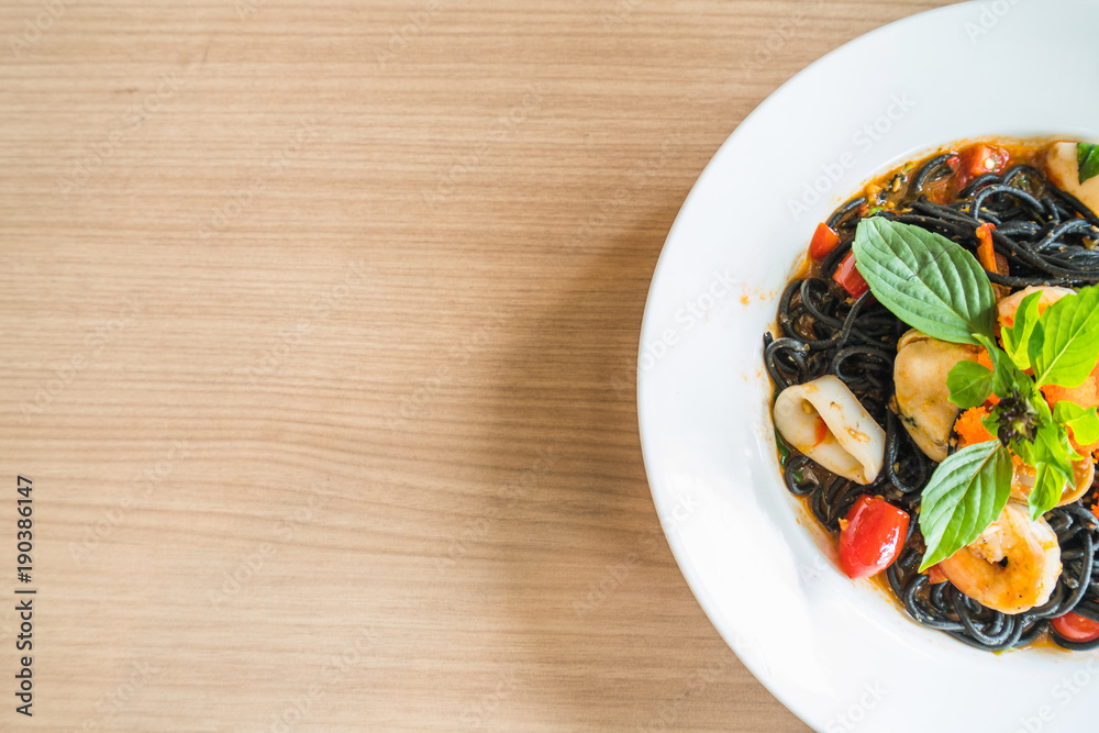 Black spaghetti on white dish in italian restaurant on the dinner