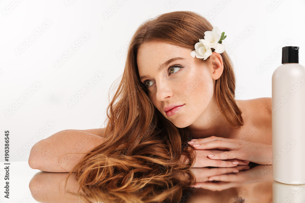 Close-up Beauty portrait of smiling woman with flower in hair Close-up Beauty portrait of smiling woman with flower in hair