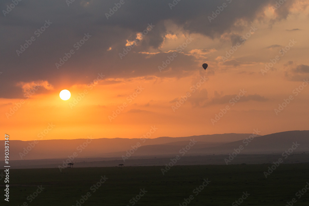 balloon against the clouds of a sunrise, Maasai Mara, Kenya balloon against the clouds of a sunrise, Maasai Mara, Kenya