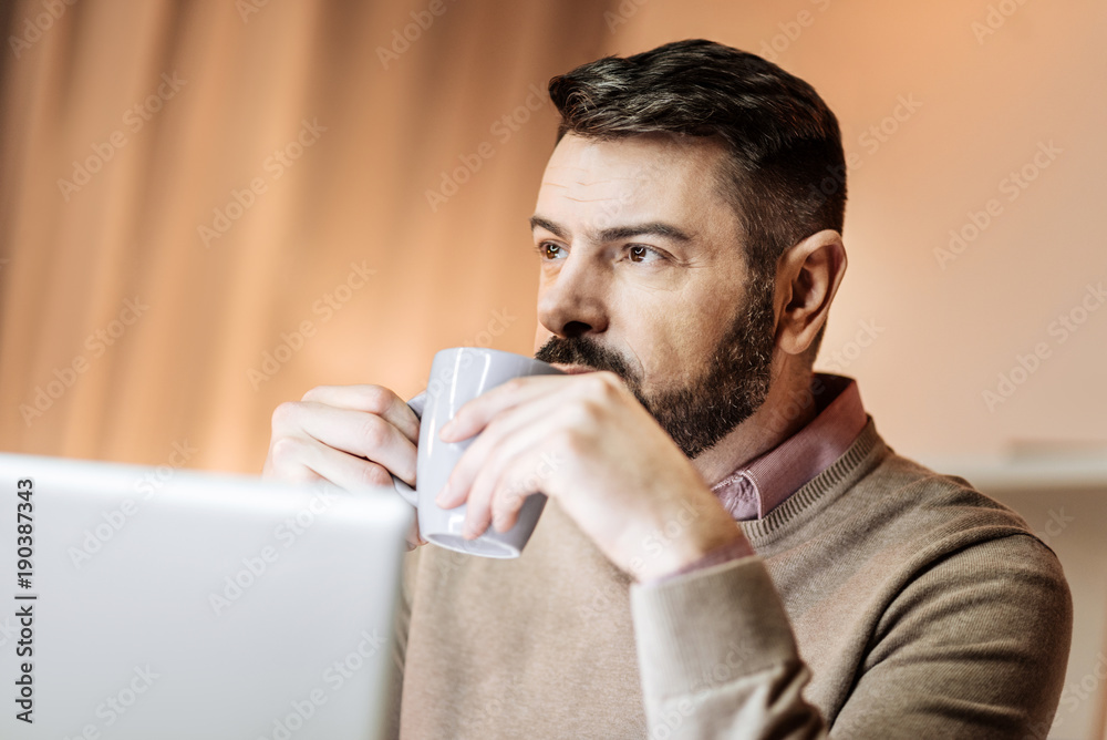 Have idea. Delighted freelancer feeling happiness while having break and drinking tea