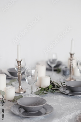 Table setting in light colors with candles