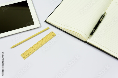 Office table with tablet, pen, notebook on white background. © ohms1999