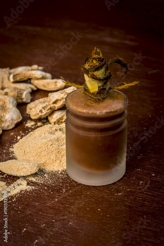 Close up of Extracted oil of dried ginger,Zingiber officinale or soth with raw dried ginger.