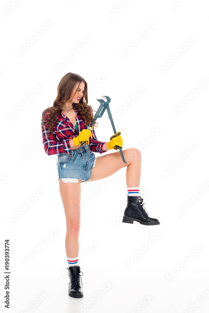 beautiful sexy girl posing with adjustable wrench, isolated on white beautiful sexy girl posing with adjustable wrench, isolated on white