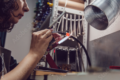 Glass blower makes the costume jewelery from the Venetian glass.