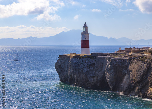 Lighthouse of Europa Point in Gibraltar overlooking the Strait with Morocco in background.