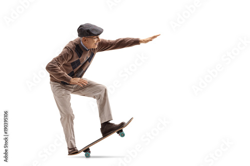 Senior riding a skateboard and doing a manual