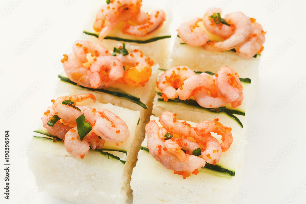 Set of rolls with soft cheese and shrimps on top, isolated Set of rolls with soft cheese and shrimps on top, isolated