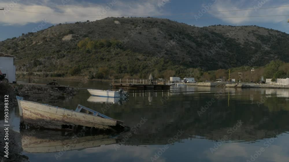 Albania, Butrint. River Ferry Boat. Damaged skiff Albania, Butrint. River Ferry Boat. Damaged skiff