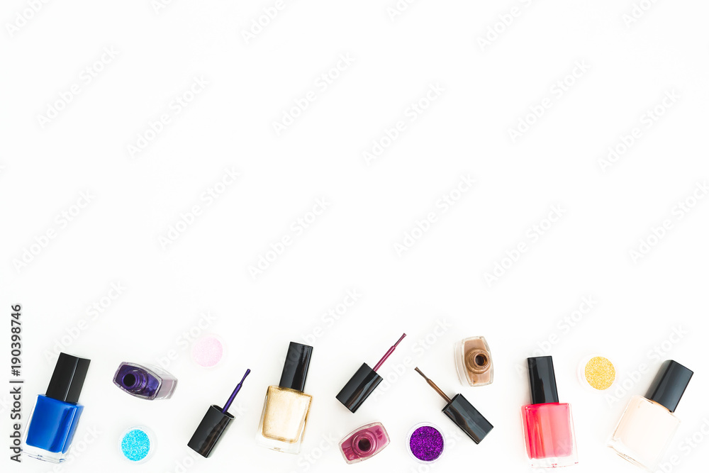 Feminine desk of bright nail polish on white background. Beauty concept. Flat lay, top view. Feminine desk of bright nail polish on white background. Beauty concept. Flat lay, top view.