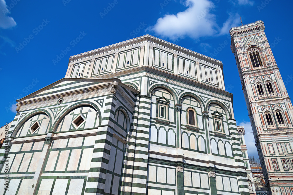 Baptistery of San Giovanni and Bell Tower in Florence. Italian Gothic style. Landmark of Tuscany. June 2017. Baptistery of San Giovanni and Bell Tower in Florence. Italian Gothic style. Landmark of Tuscany. June 2017.
