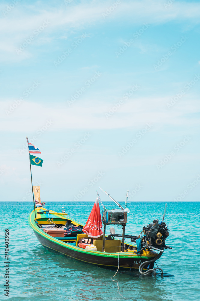 Asian boat with fisher equipment in blue water