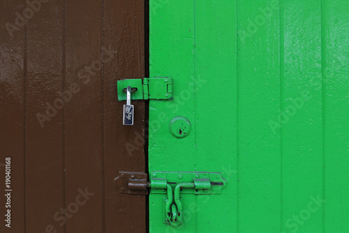 Old bronze master key with vivid color brown and green chiness wooden door,town bangkok thailand © 22August