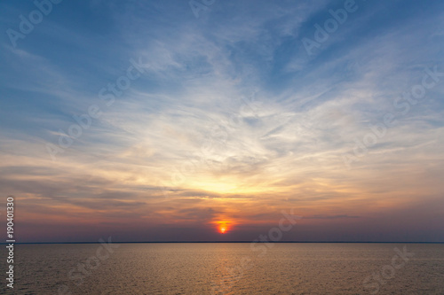 Sitting the sun against the sky. The sky is sunset. © Oleg