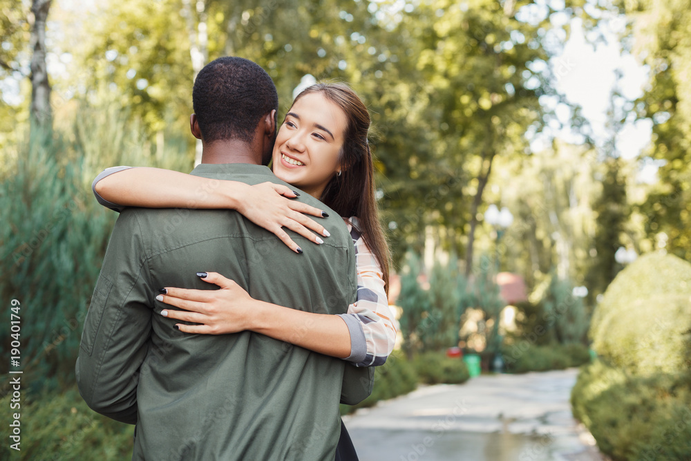 Fototapeta premium Happy couple hugging in park copy space