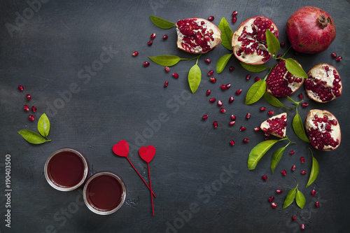 Pomegranate and freshly squeezed pomegranate juice on a vintage background. Top view, background.
