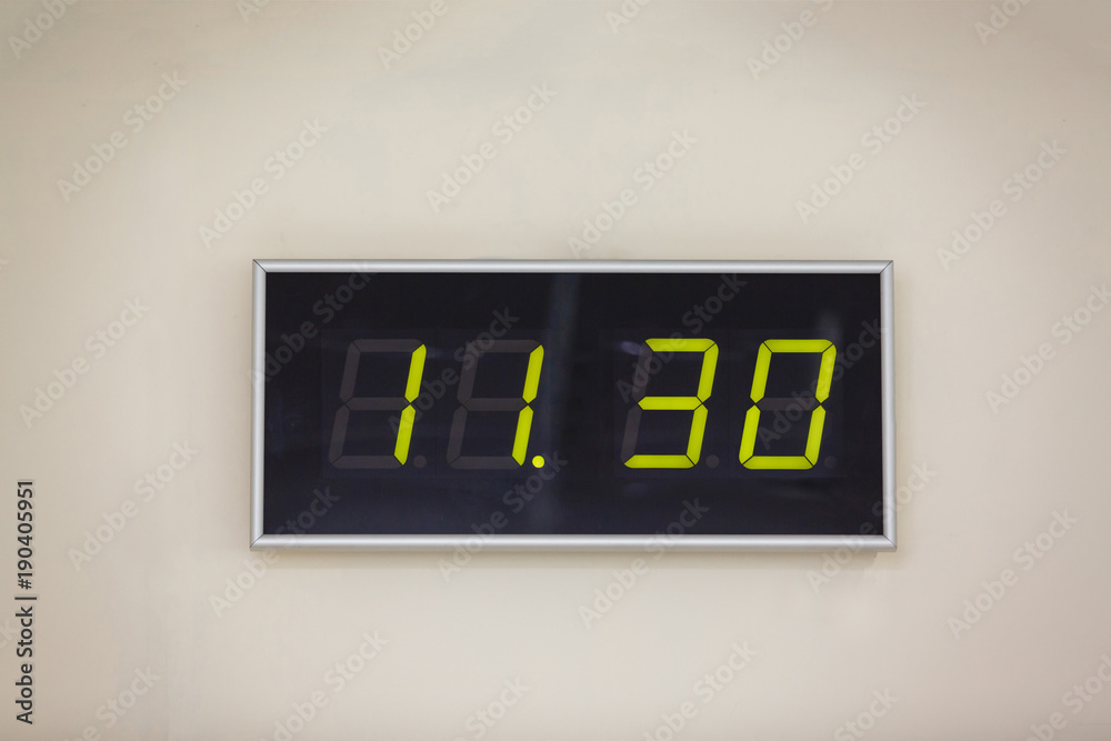 Black digital clock on a white background showing time 11 hours 30 minutes  Photos | Adobe Stock