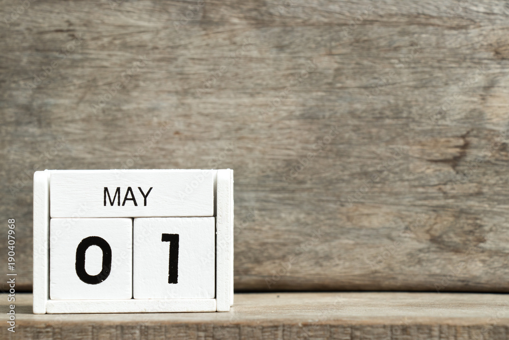 White block calendar present date 1 and month May on wood background White block calendar present date 1 and month May on wood background