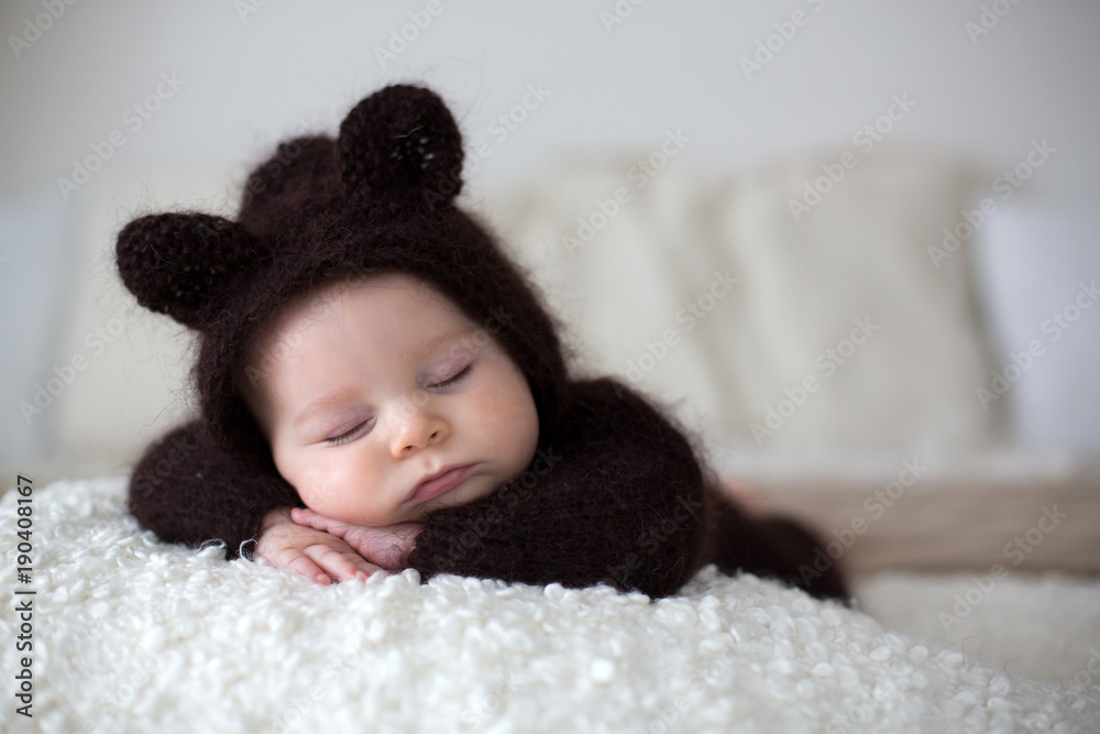 Sweet little baby boy, dressed in handmade knitted brown soft teddy bear overall, sleeping cozy Sweet little baby boy, dressed in handmade knitted brown soft teddy bear overall, sleeping cozy
