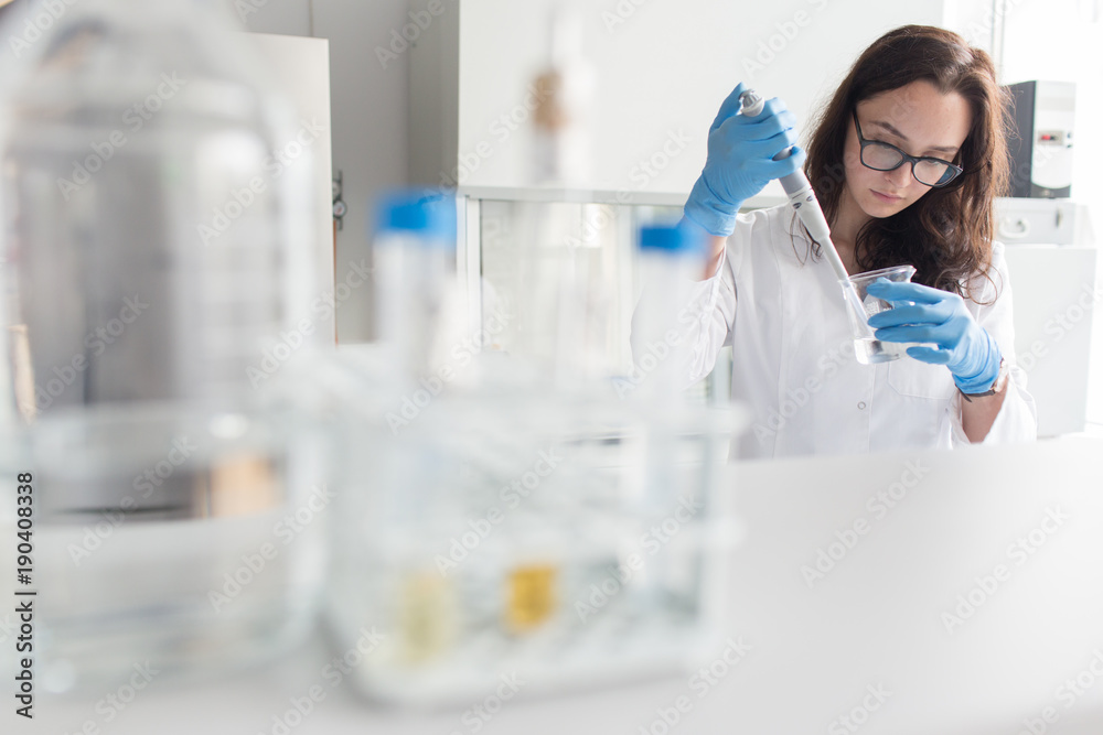 Woman holding flask in lab Woman holding flask in lab