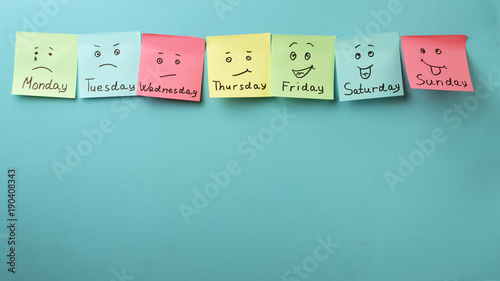 Day of week and face expression. Colored stickers on a blue background photo