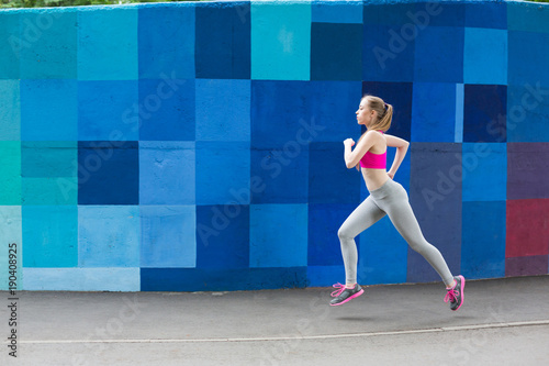 Young woman running in city copy space