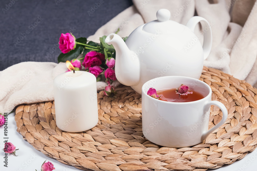 Herbal tea, pink roses and teapot on the coffee table Herbal tea, pink roses and teapot on the coffee table