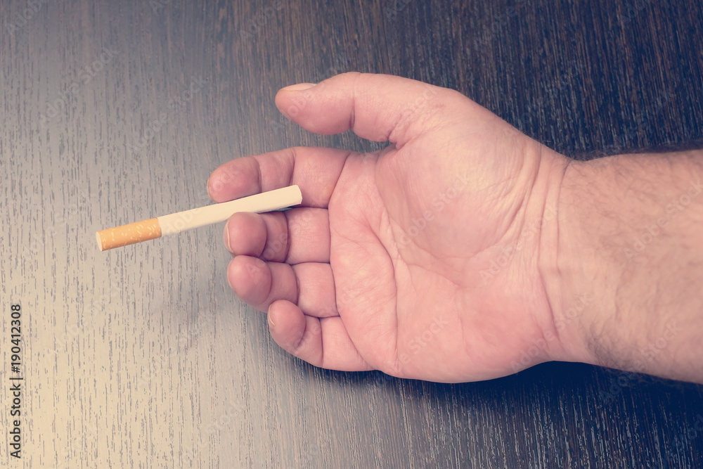 hand offering a cigarette, toned