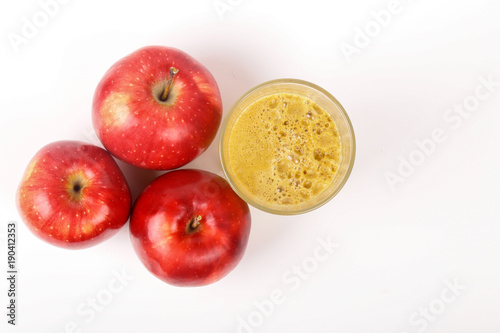 Red apples and a glass of fresh juice isolated on white background