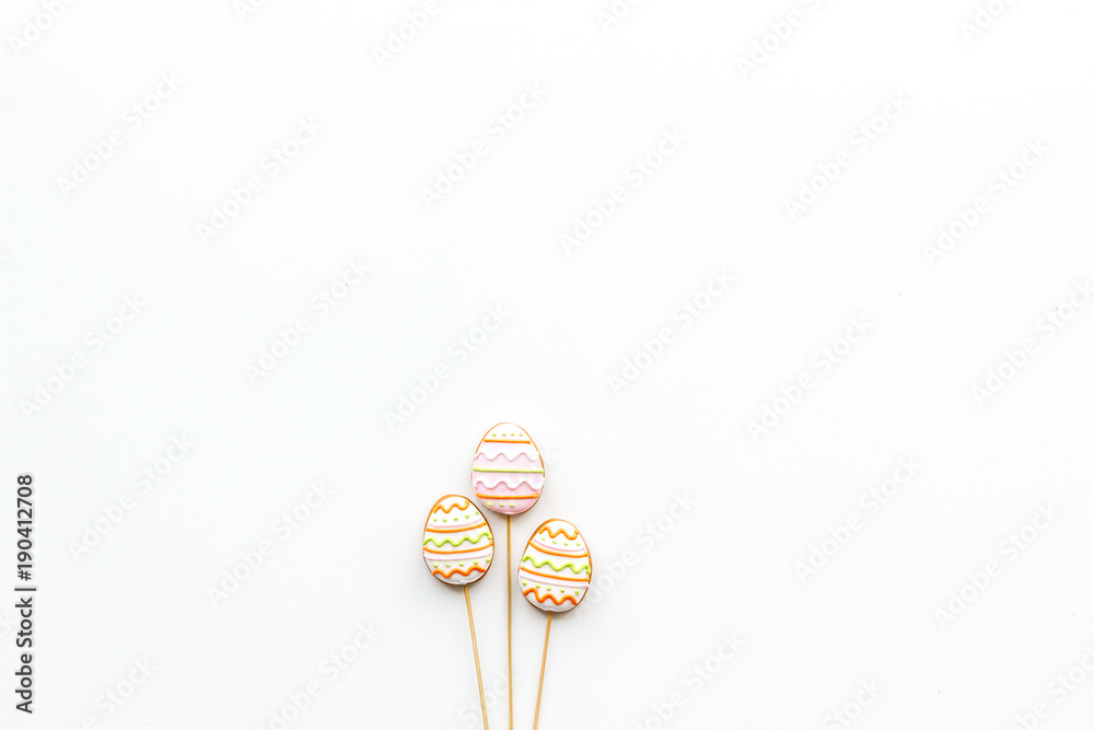 Easter gingerbread and cookies in shape of Easter eggs. White background top view copy space Easter gingerbread and cookies in shape of Easter eggs. White background top view copy space