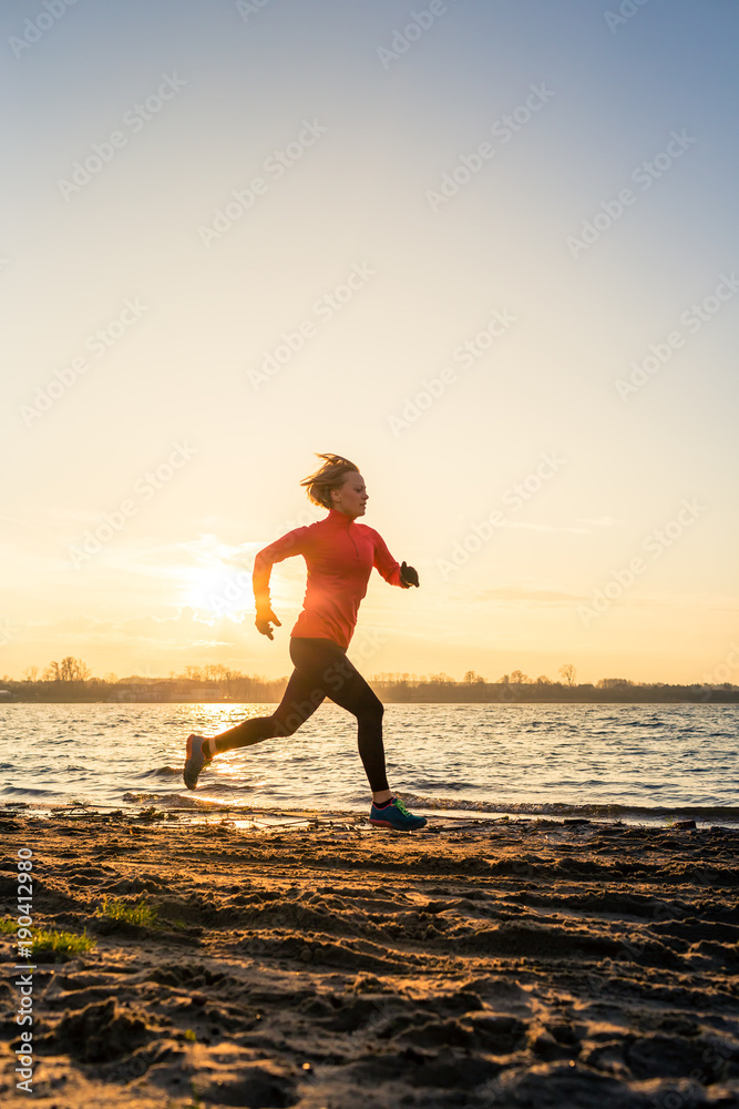 Beach jogging at sunrise, lake coastline